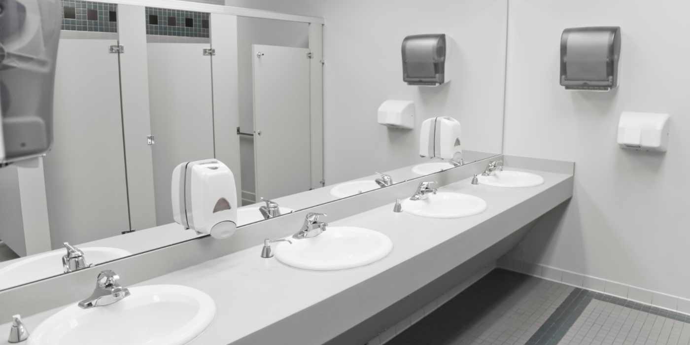 Clean commercial restroom after cleaning and disinfecting