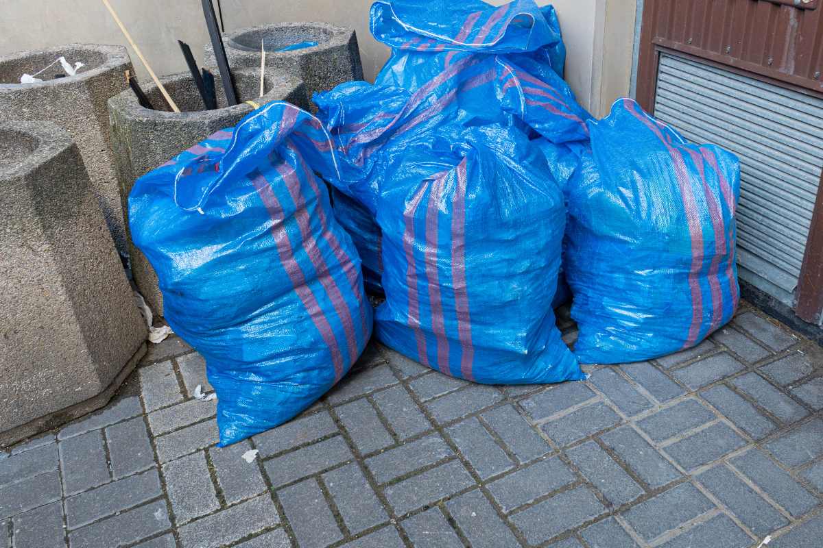 Recycling material removal in action with large bags and container