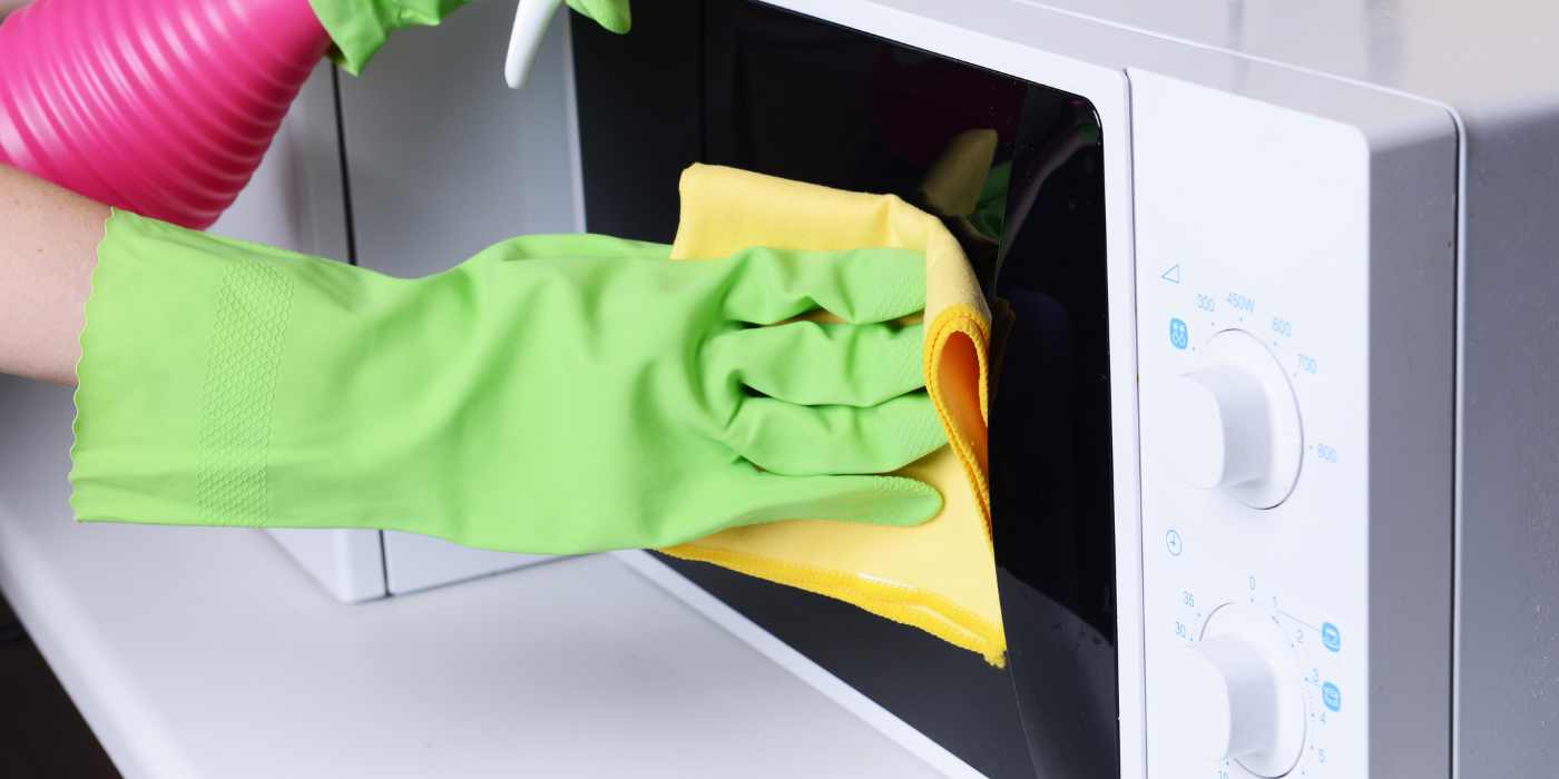 Microwave oven cleaning close up in kitchen