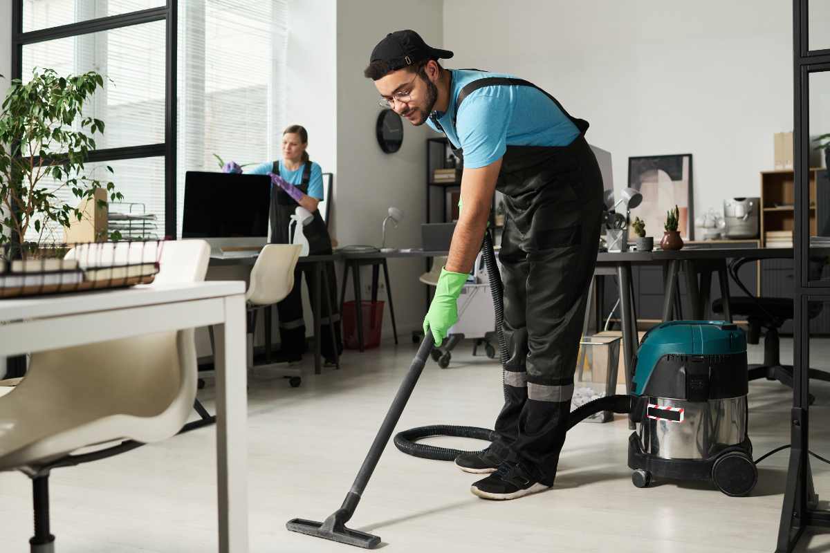 Office cleaning worker cleaning conference room and office space