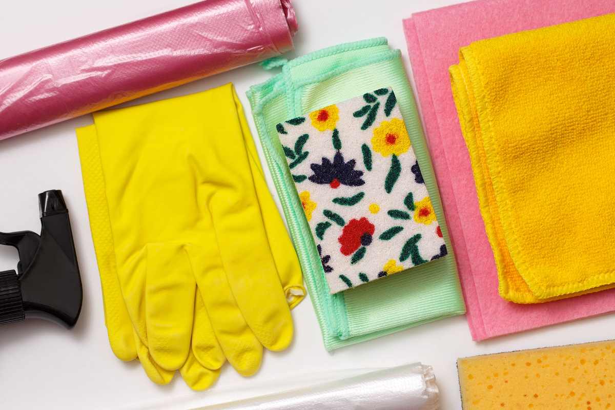 Appliance cleaning supplies including gloves cloths spray and sponges