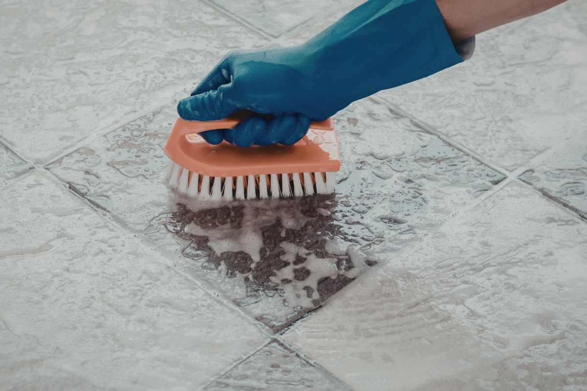 Deep floor cleaning with brush on tile floor