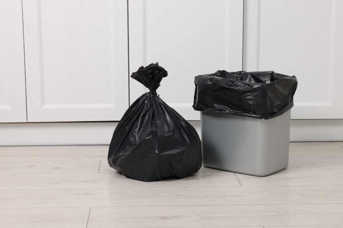 Residential waste material removal with household trash bags