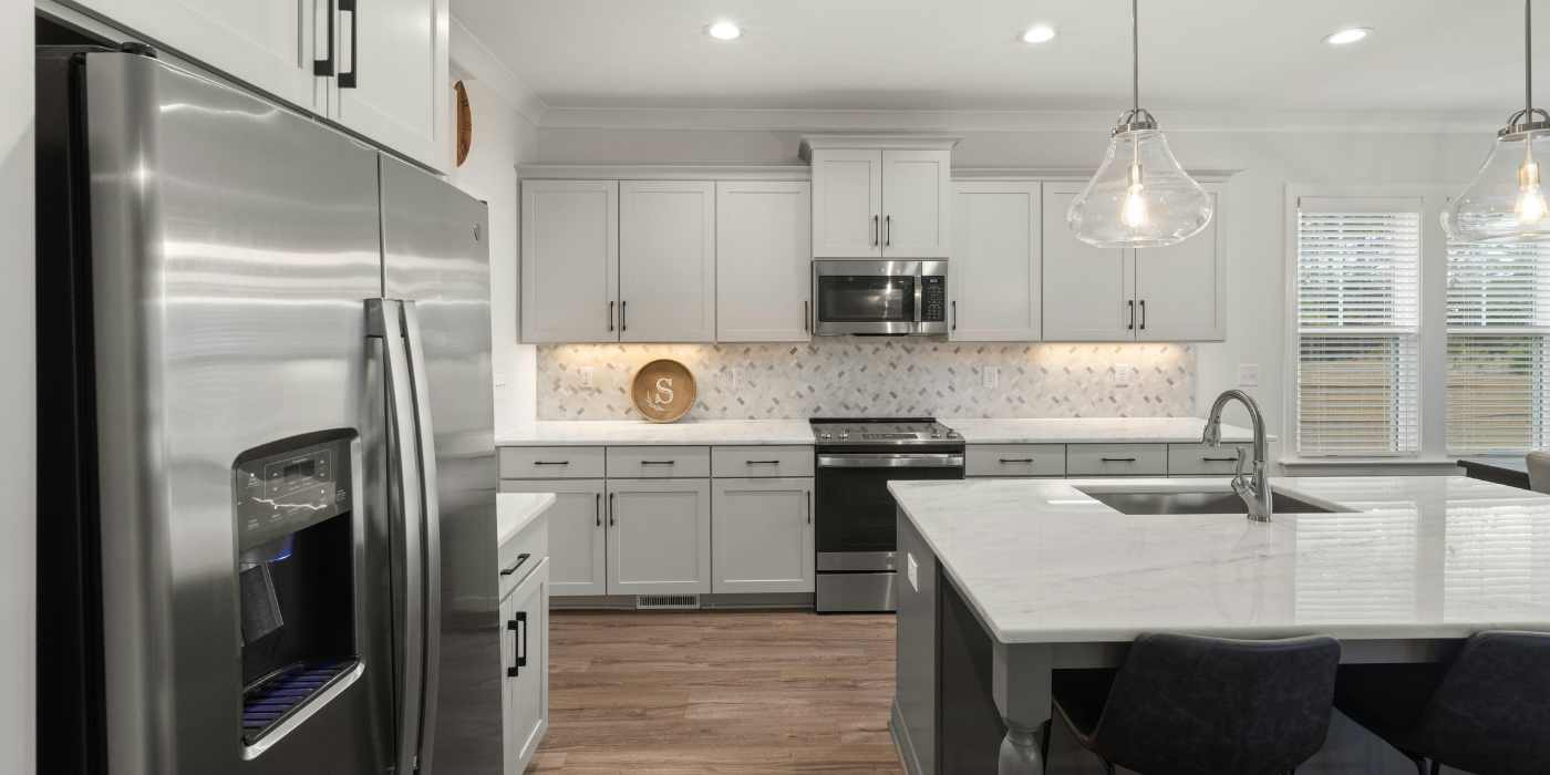 Modern kitchen with clean appliances after cleaning service