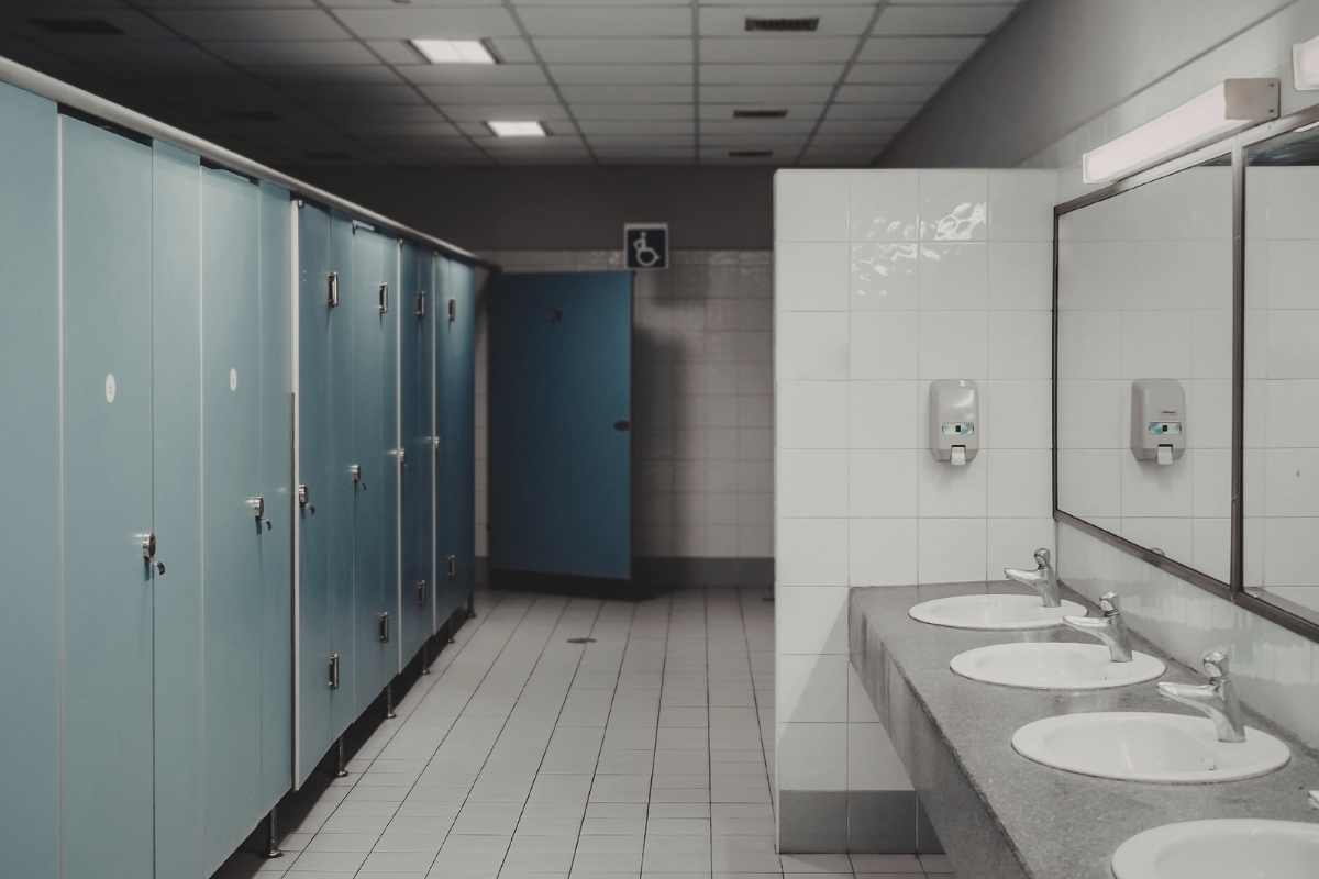 Clean modern public restroom with stalls and sinks