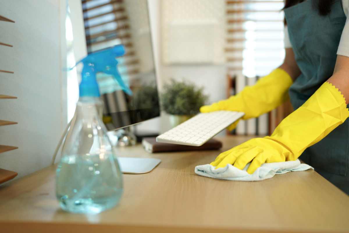 Cleaner wiping office furniture and tables
